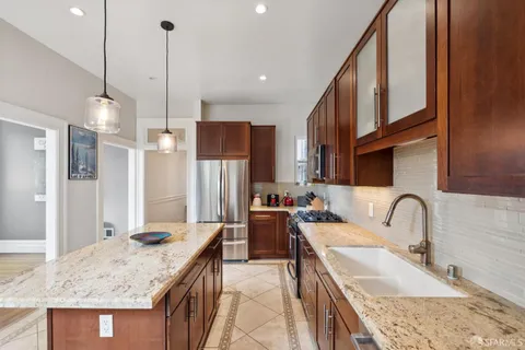 a kitchen with a refrigerator and a sink