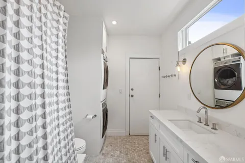 a white toilet sitting next to a bathroom sink