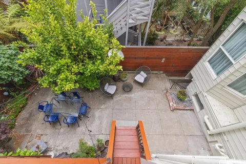 a backyard of a house with outdoor seating