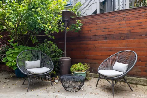 a backyard of a house with table and chairs