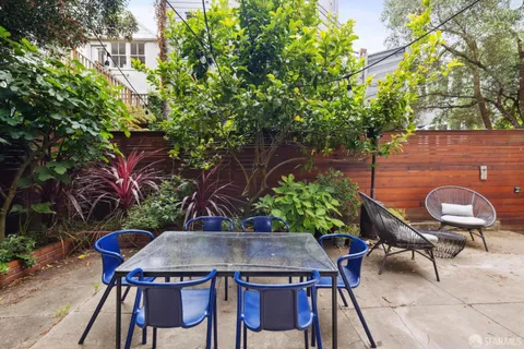 a view of a roof deck with chair and wooden floor