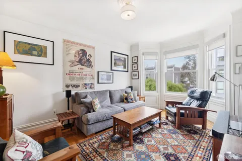 a living room with furniture and painting on the wall