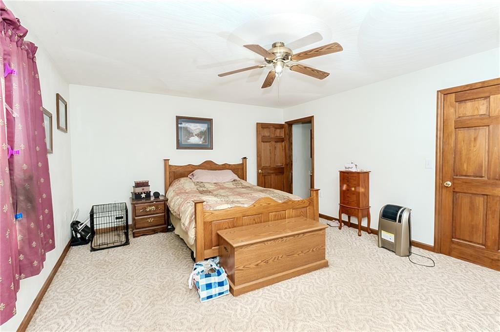 686 North Ridge Road Shelocta, PA 15774 - Photo 13 of 31 a bedroom with a bed and a chandelier
