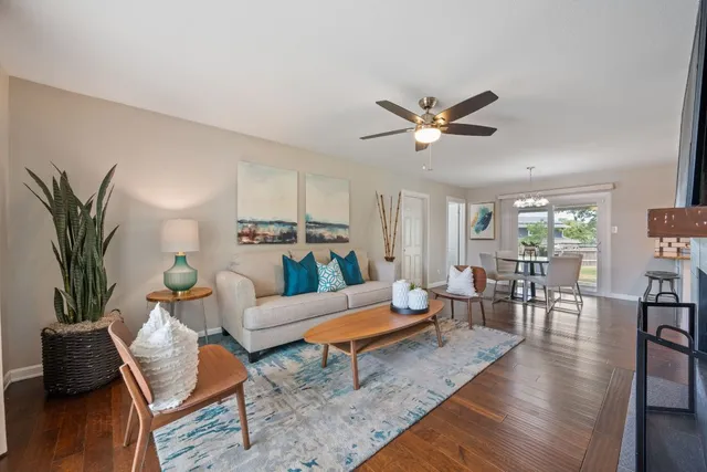 a living room with furniture and wooden floor