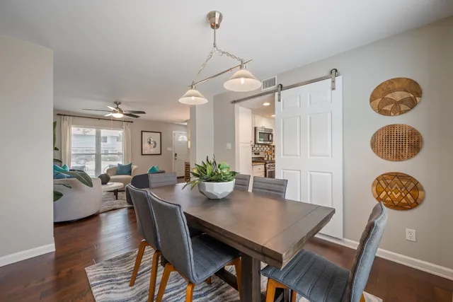 a view of a dining room with furniture and wooden floor