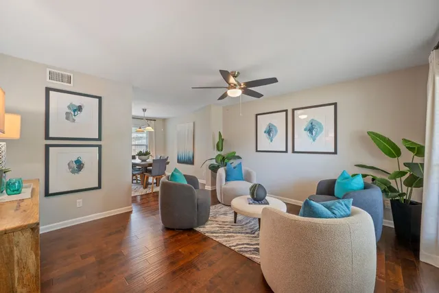 a living room with furniture and a potted plant