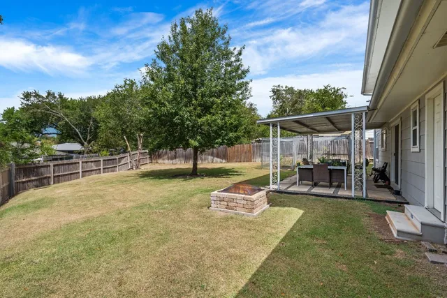 a view of a backyard with swimming pool
