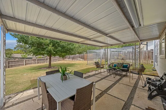 a view of a patio with table and chairs and potted plants