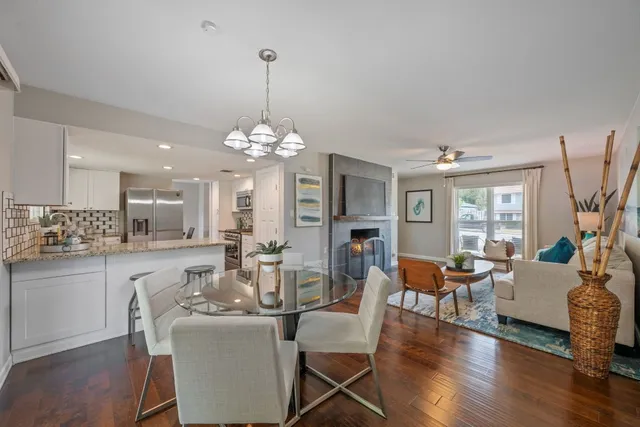 a view of a dining room with furniture wooden floor and chandelier
