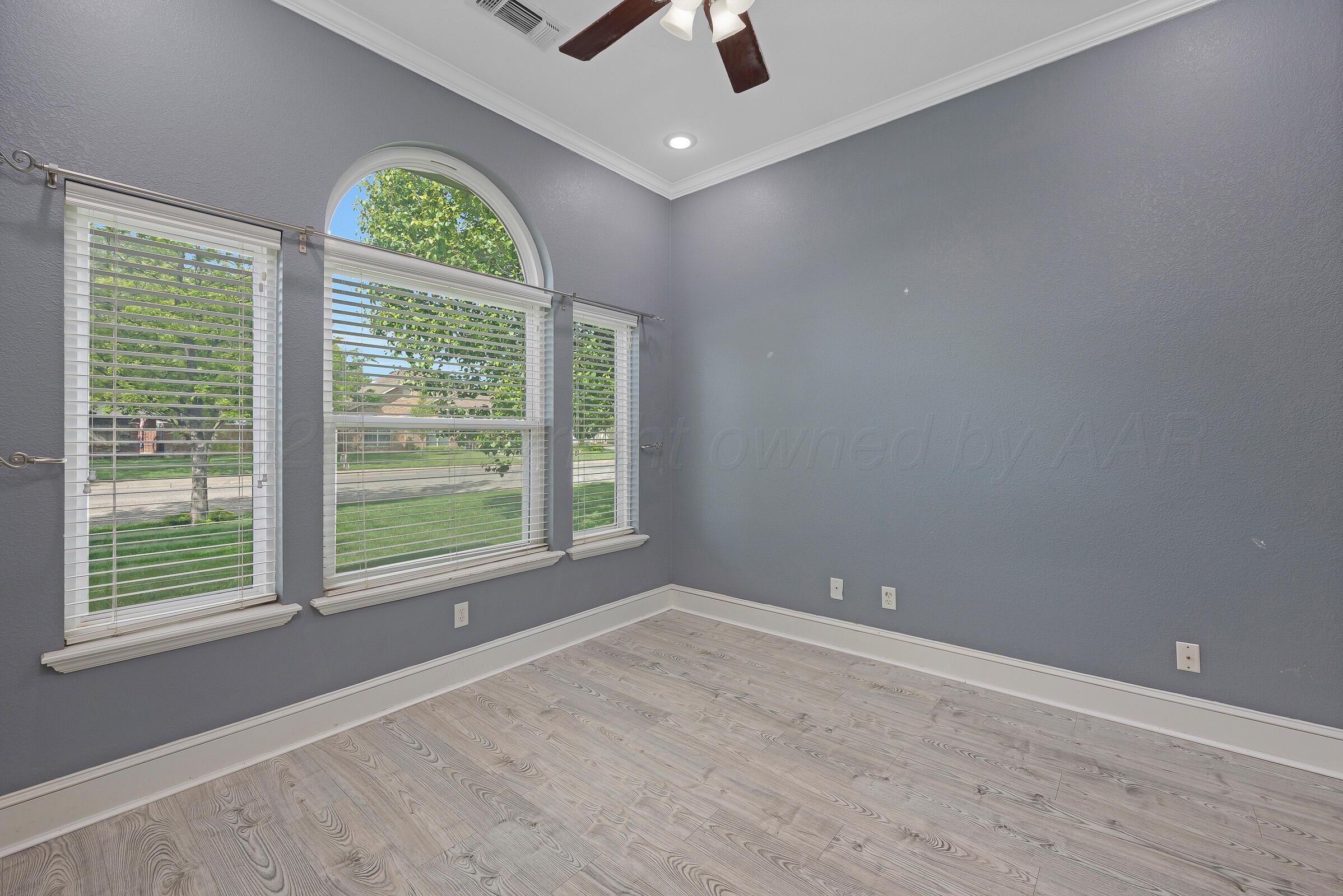 8211 Challenge Drive Amarillo, TX 79119 - Photo 12 of 31 an empty room with windows and natural light