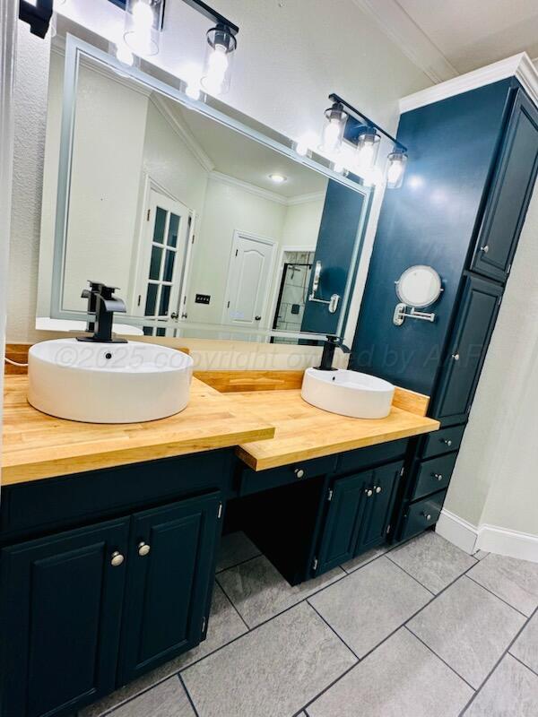 8211 Challenge Drive Amarillo, TX 79119 - Photo 17 of 31 a bathroom with a sink and a mirror