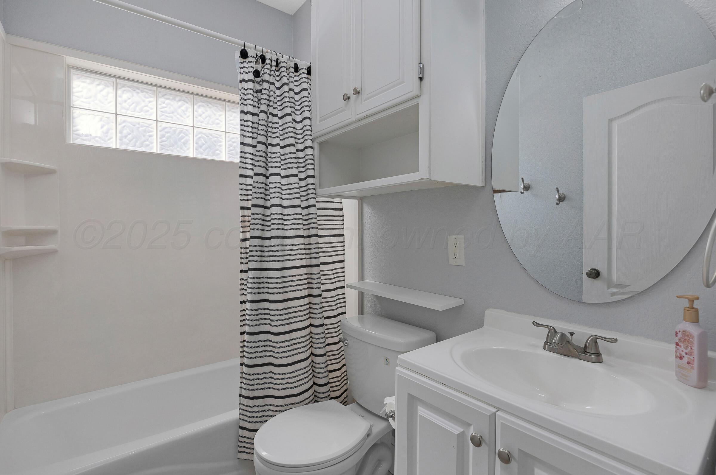 8211 Challenge Drive Amarillo, TX 79119 - Photo 23 of 31 a bathroom with a sink toilet and shower