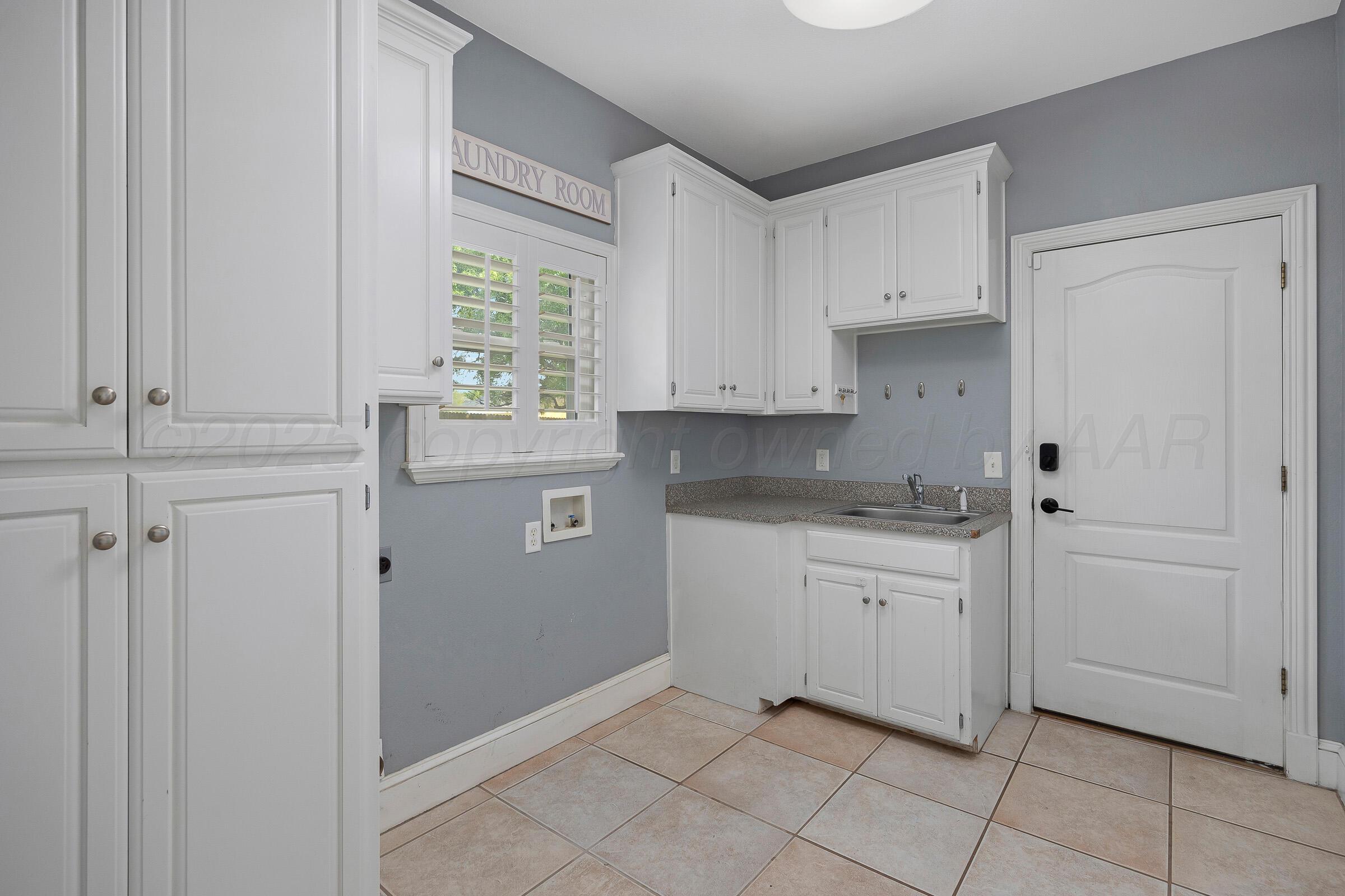8211 Challenge Drive Amarillo, TX 79119 - Photo 24 of 31 a kitchen with white cabinets and window