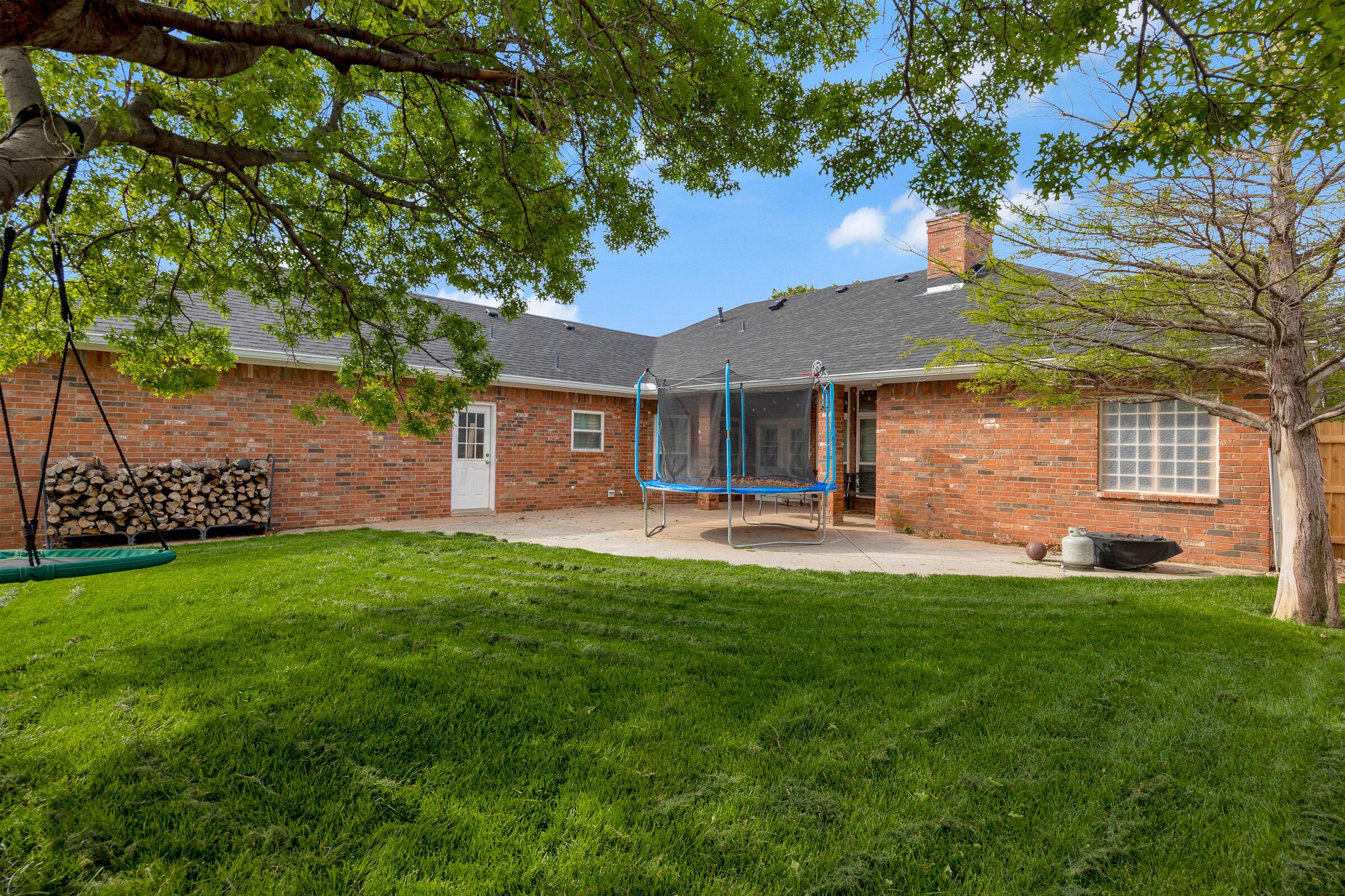 8211 Challenge Drive Amarillo, TX 79119 - Photo 25 of 31 a front view of a house with a garden