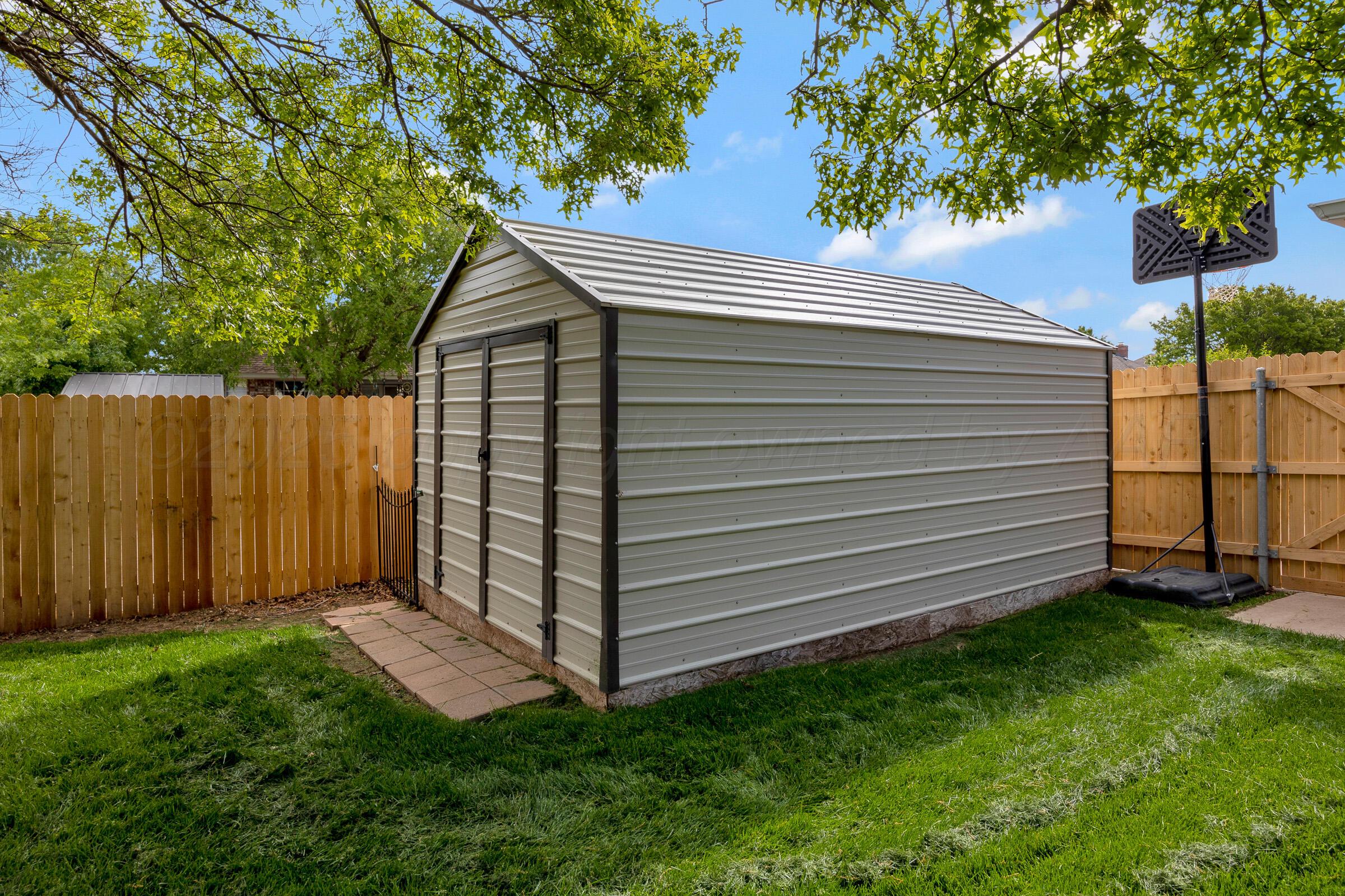 8211 Challenge Drive Amarillo, TX 79119 - Photo 29 of 31 a view of a backyard with a large tree