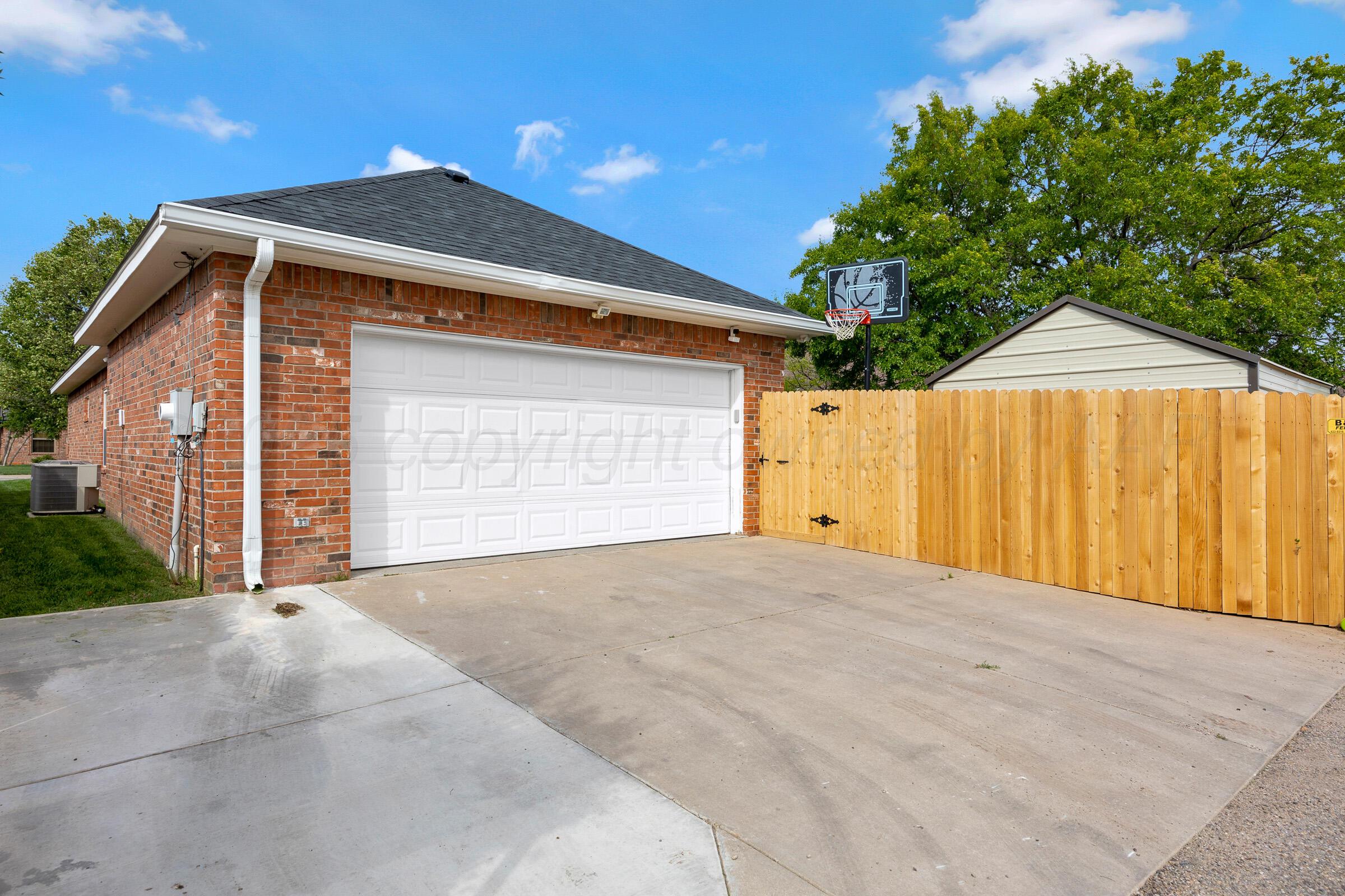 8211 Challenge Drive Amarillo, TX 79119 - Photo 30 of 31 a front view of a house with a garage