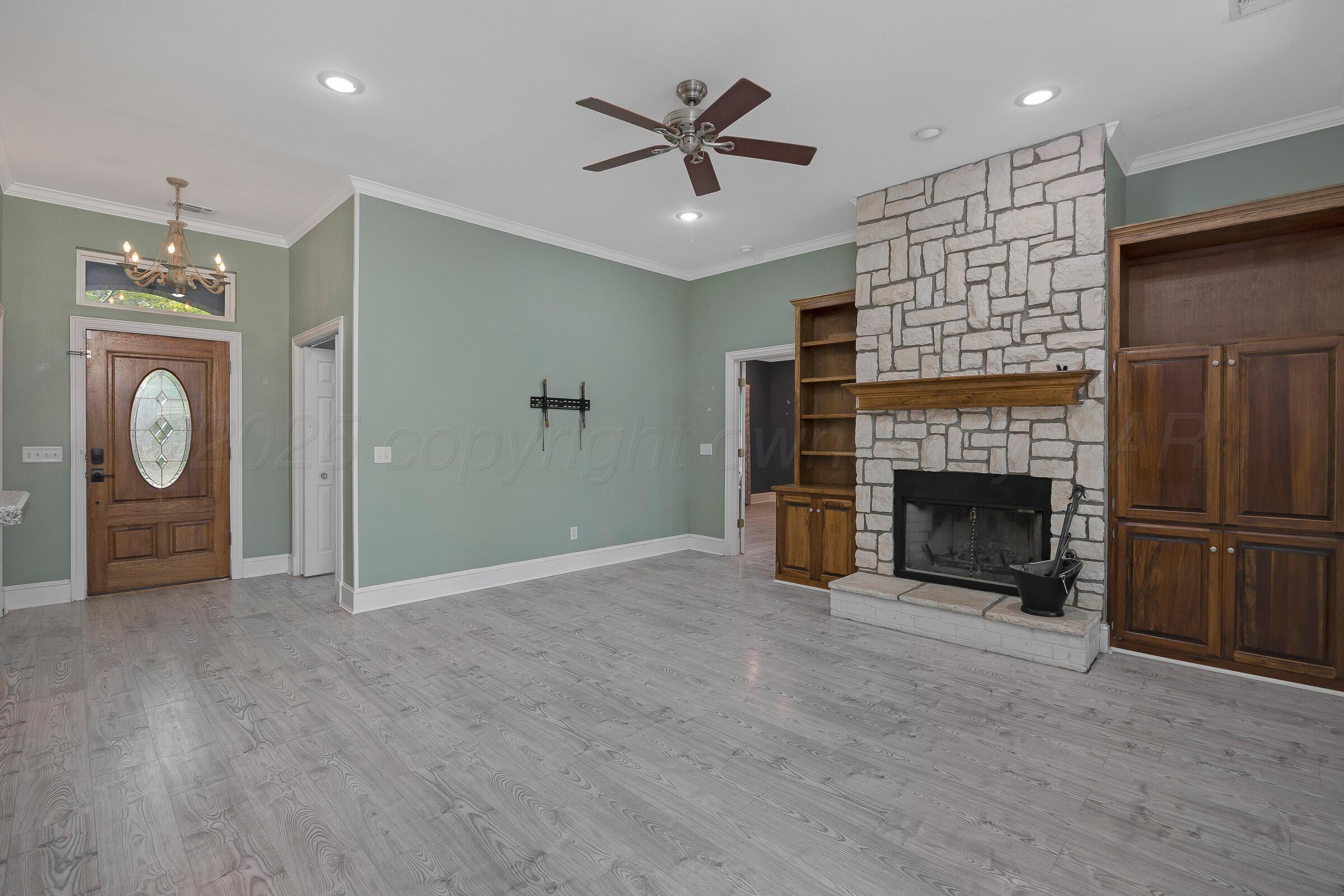 8211 Challenge Drive Amarillo, TX 79119 - Photo 4 of 31 a view of an empty room with a fireplace and a window