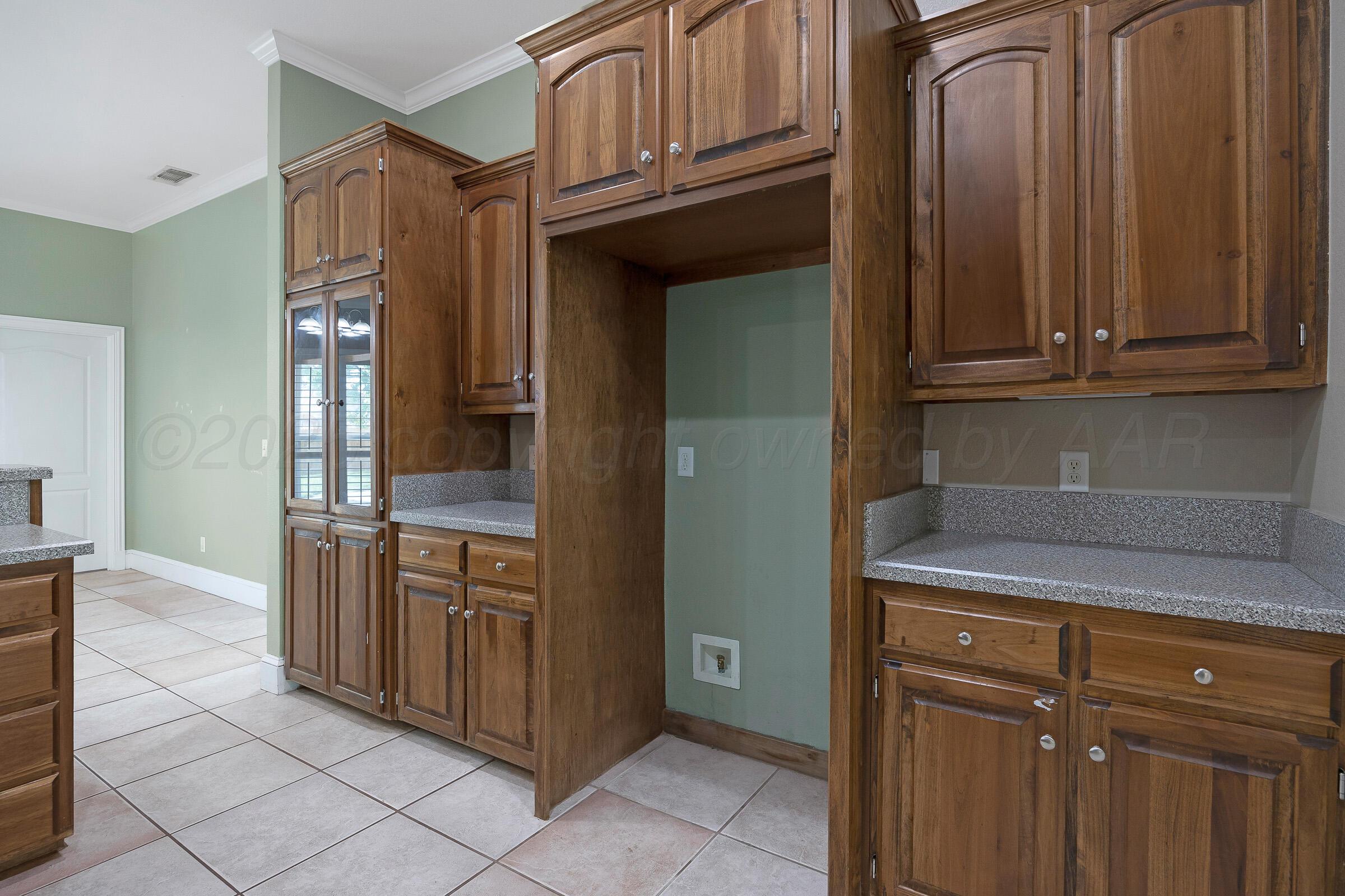 8211 Challenge Drive Amarillo, TX 79119 - Photo 8 of 31 a kitchen with stainless steel appliances granite countertop a refrigerator and cabinets