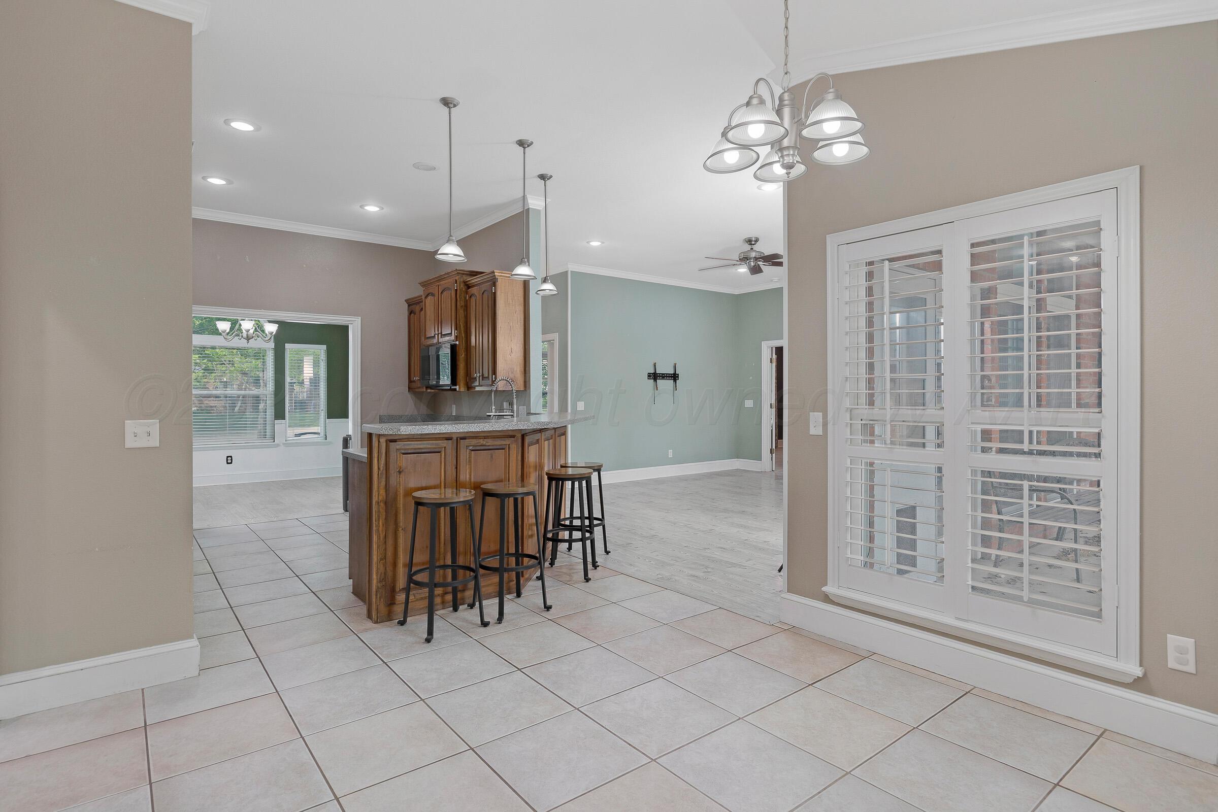 8211 Challenge Drive Amarillo, TX 79119 - Photo 10 of 31 a view of kitchen with granite countertop cabinets and chandelier