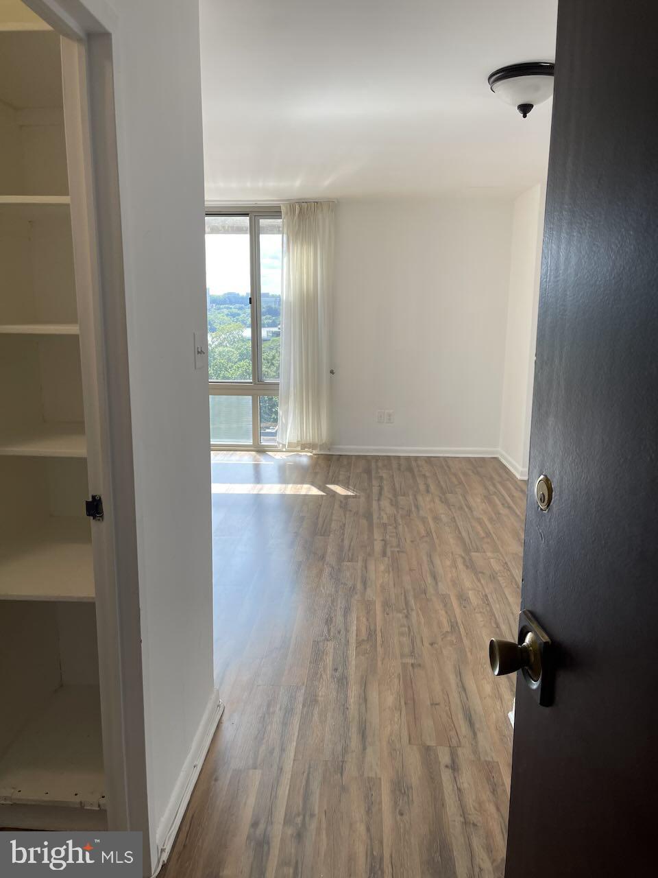 950 25th Street Northwest, Unit 1013N Washington, DC 20037 - Photo 11 of 27 wooden floor in an empty room with a window