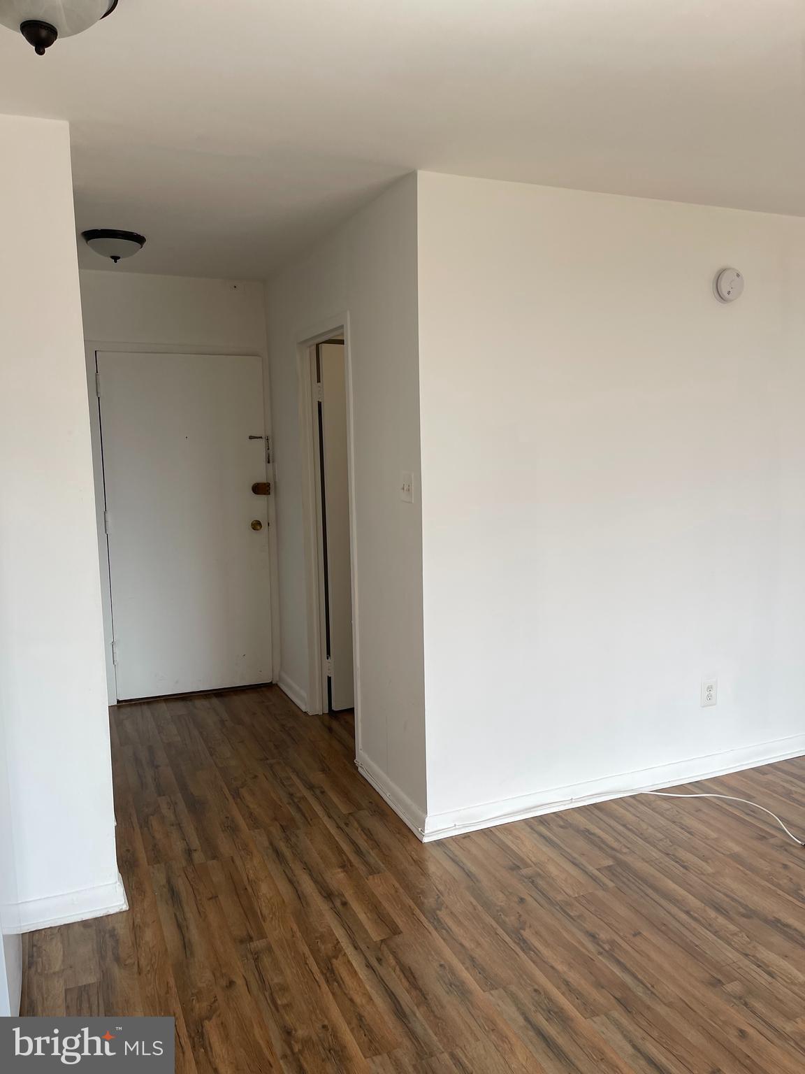 950 25th Street Northwest, Unit 1013N Washington, DC 20037 - Photo 5 of 27 a view of an empty room with wooden floor