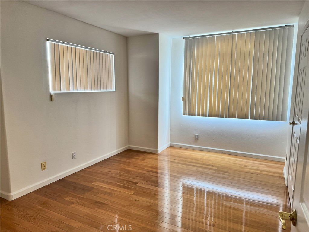 18319 Hart Street, Unit 3 Reseda, CA 91335 - Photo 11 of 18 a view of an empty room with wooden floor and a window