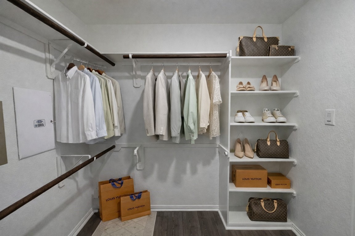 231 Moon Dance Court Conroe, TX 77304 - Photo 12 of 22 a view of walk in closet with clothes and shoes
