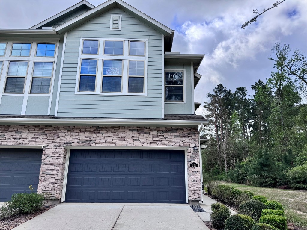 231 Moon Dance Court Conroe, TX 77304 - Photo 2 of 22 a front view of a house with garage