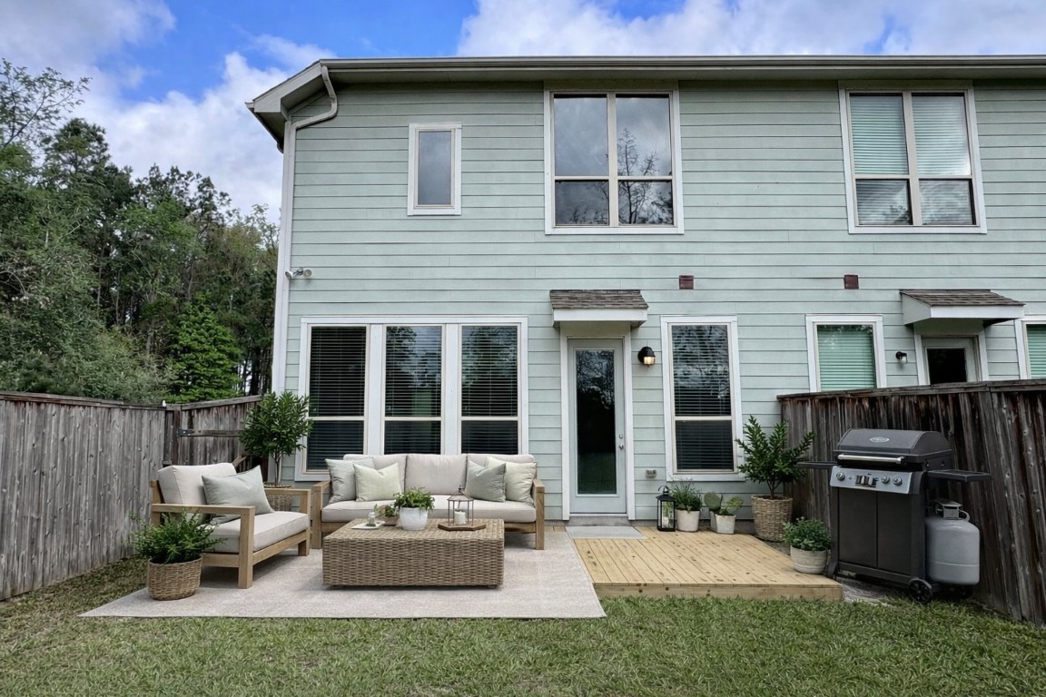 231 Moon Dance Court Conroe, TX 77304 - Photo 21 of 22 a view of a house with a yard and furniture