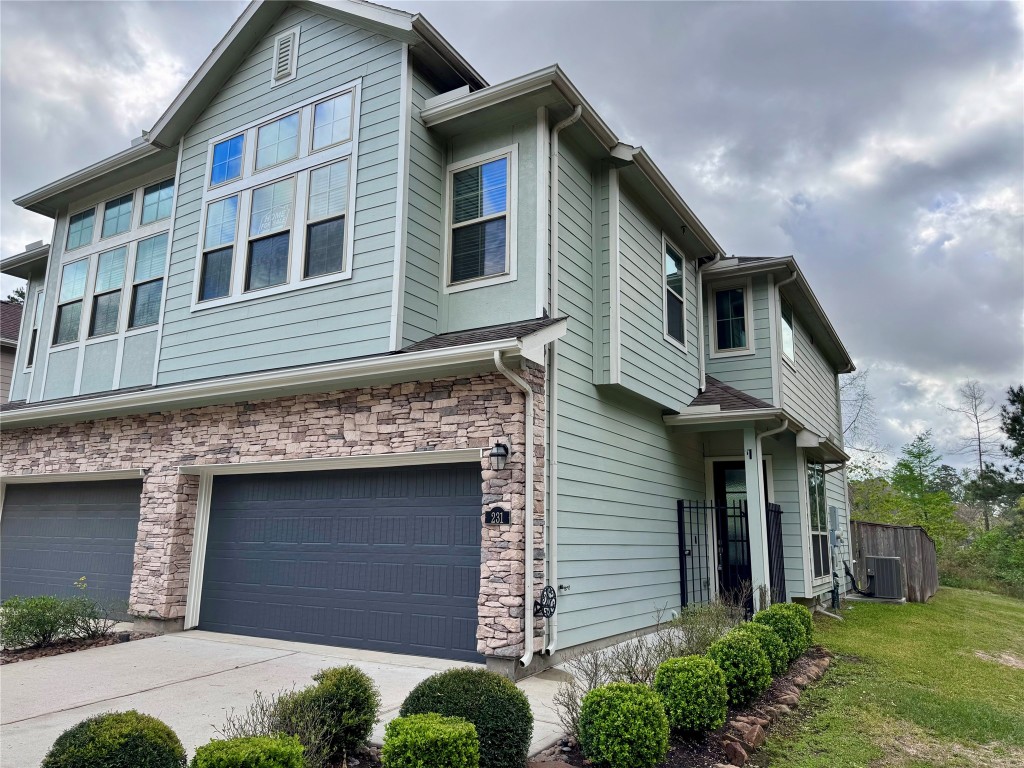 231 Moon Dance Court Conroe, TX 77304 - Photo 3 of 22 a front view of a house with garage
