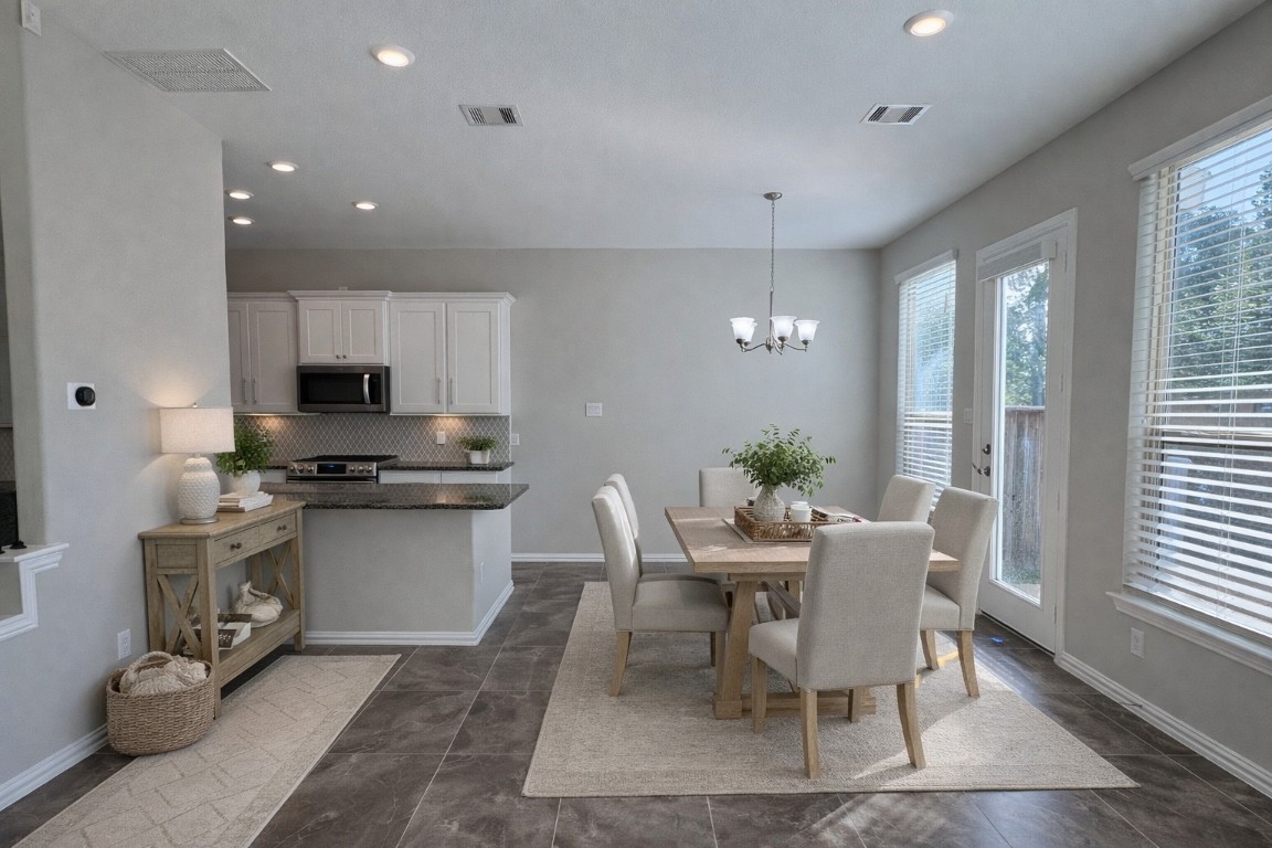231 Moon Dance Court Conroe, TX 77304 - Photo 6 of 22 a view of a dining room with furniture window and wooden floor