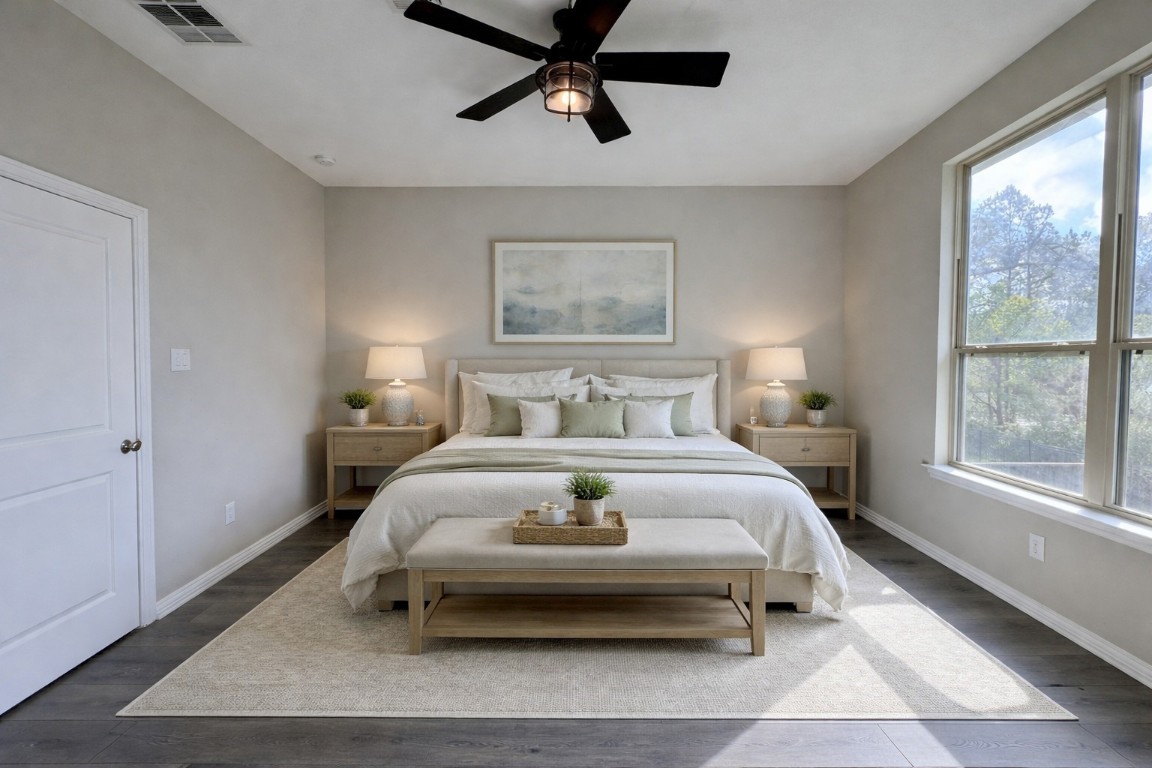 231 Moon Dance Court Conroe, TX 77304 - Photo 9 of 22 a bedroom with a bed a window and couch