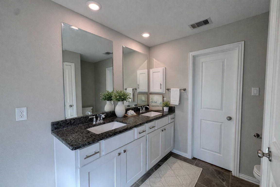 231 Moon Dance Court Conroe, TX 77304 - Photo 10 of 22 a bathroom with a granite countertop sink and a mirror