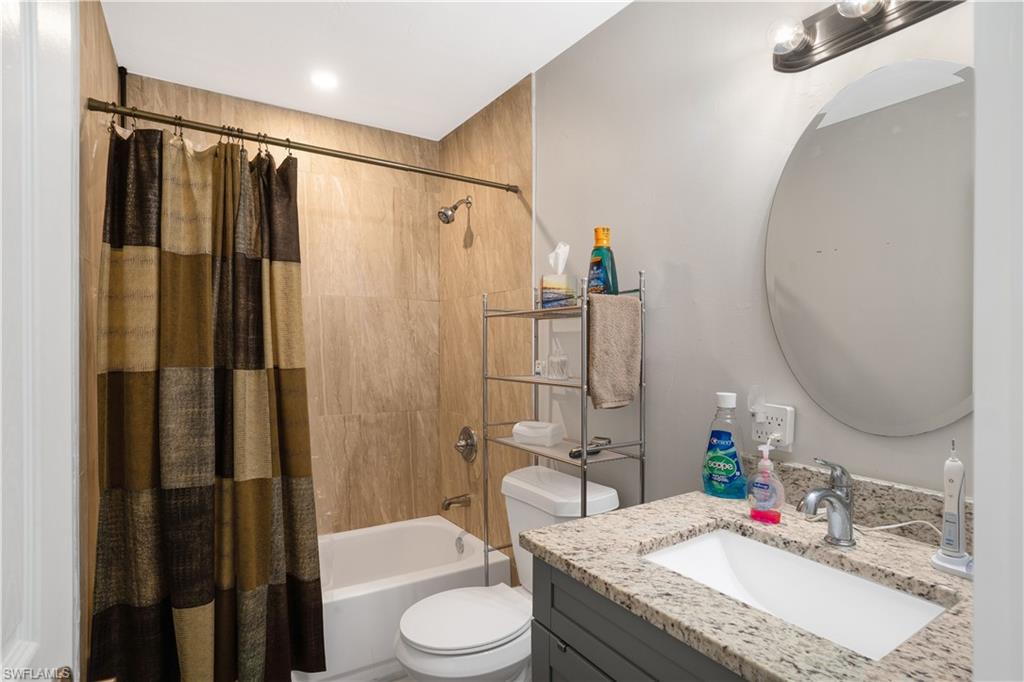 4500 30th Place Southwest Naples, FL 34116 - Photo 12 of 15 a bathroom with a granite countertop sink toilet and shower