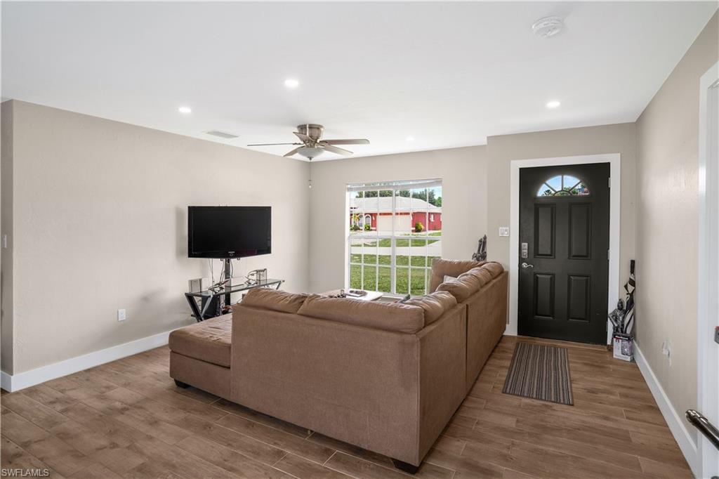 4500 30th Place Southwest Naples, FL 34116 - Photo 3 of 15 a living room with furniture and a flat screen tv