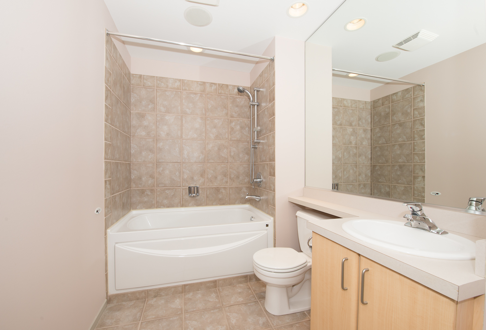 Undisclosed Address Chicago, IL 60607 - Photo 15 of 18 a bathroom with a bathtub shower sink vanity mirror and toilet