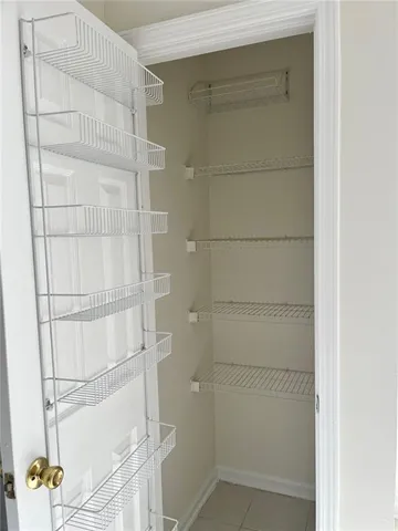 a spacious bathroom with a granite countertop sink a mirror and a bathtub