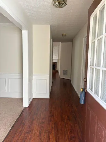 wooden floor in an empty room with a window