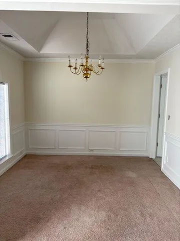 a view of a refrigerator in an empty room