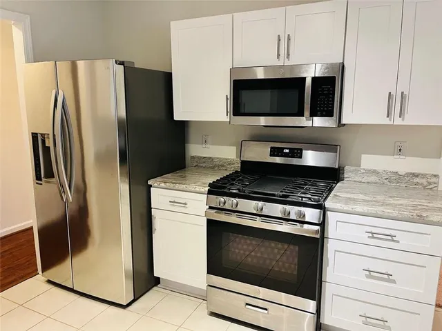 a kitchen with a sink and a wooden floor