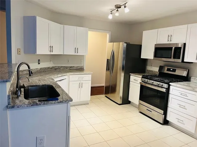 a living room with a fireplace and a fireplace