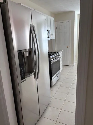 a kitchen with stainless steel appliances a refrigerator and a counter top
