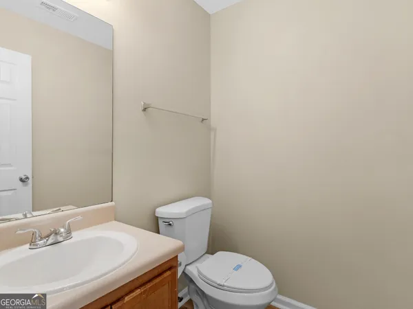 a white toilet sitting next to a white sink