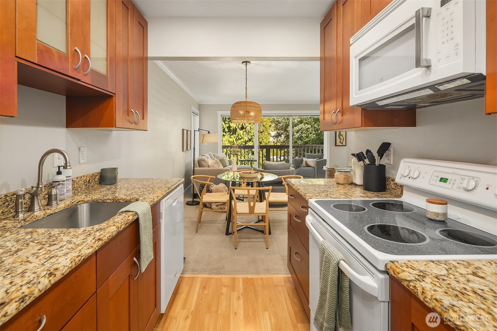 5021 Ripley Lane North, Unit 211 Renton, WA 98056 - Photo 12 of 25 a kitchen with a sink a stove and cabinets