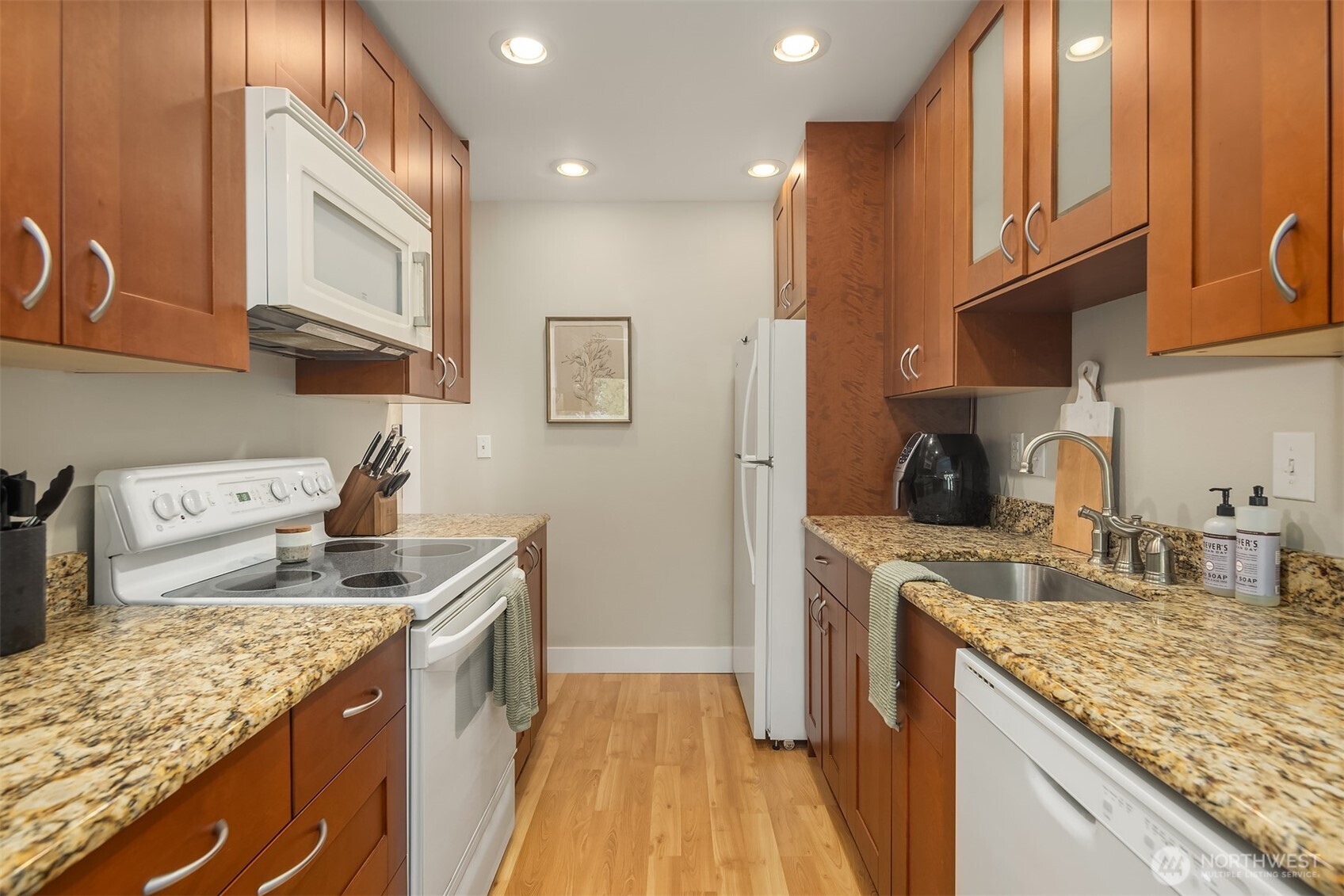 5021 Ripley Lane North, Unit 211 Renton, WA 98056 - Photo 13 of 25 a kitchen with stainless steel appliances granite countertop a sink stove and refrigerator