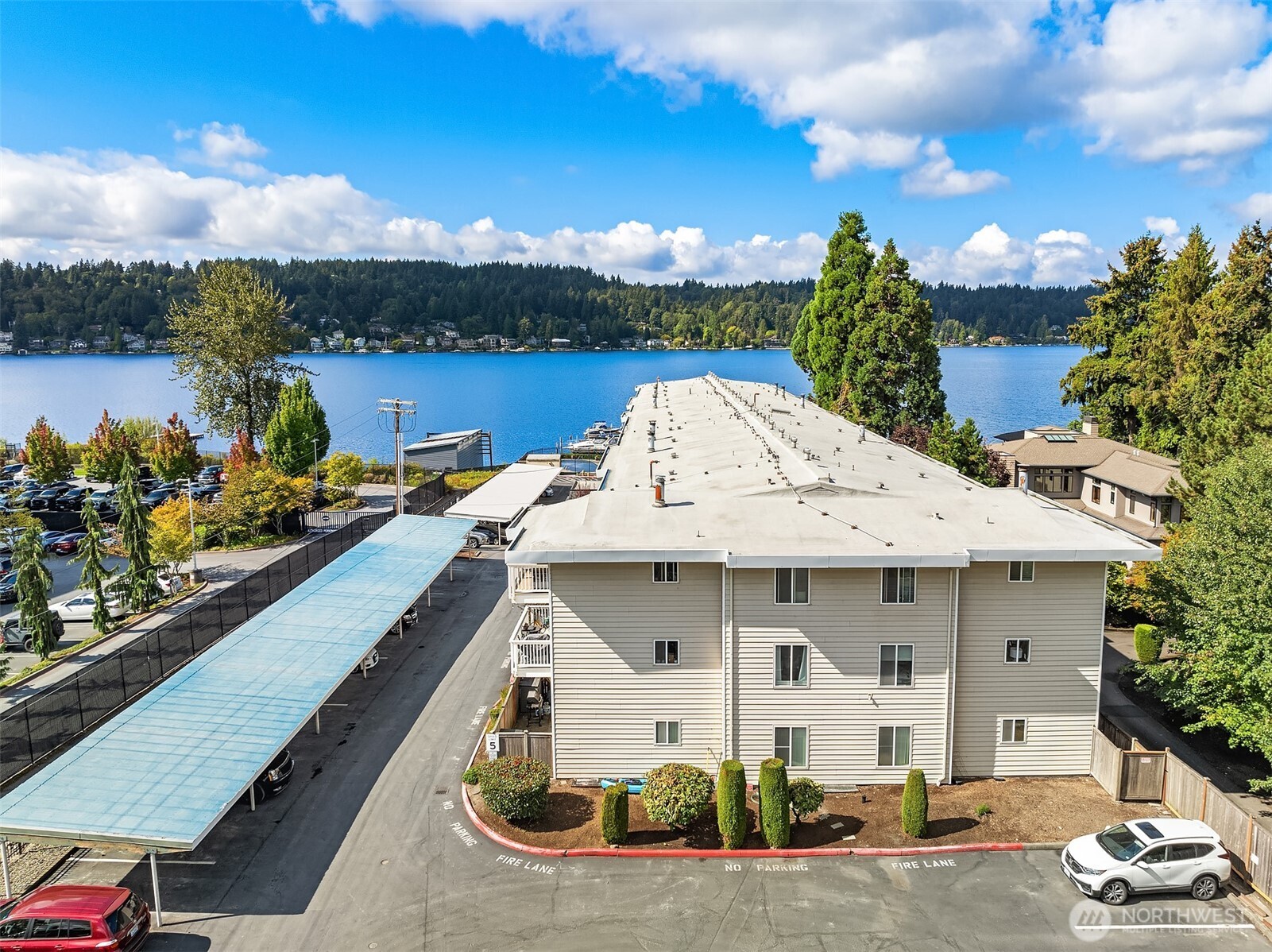 5021 Ripley Lane North, Unit 211 Renton, WA 98056 - Photo 22 of 25 a view of a house with outdoor seating area and lake view