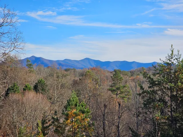 a spacious bedroom with a bed and a flat screen tv