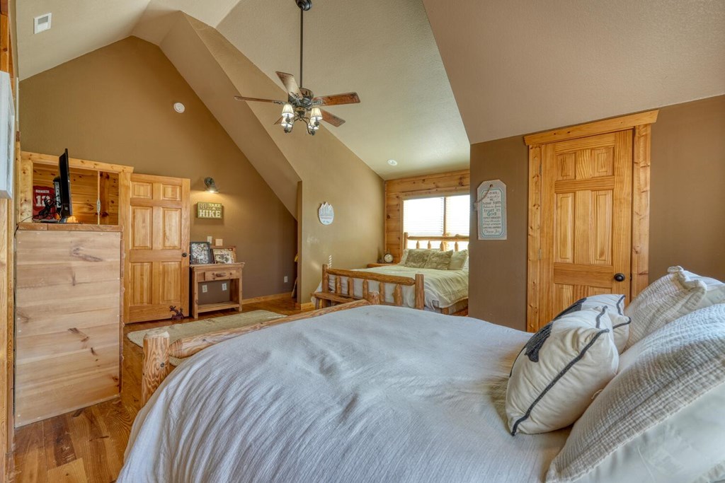 2567 Todd Shook Road Young Harris, GA 30582 - Photo 34 of 62 a bed room with a bed and a chandelier