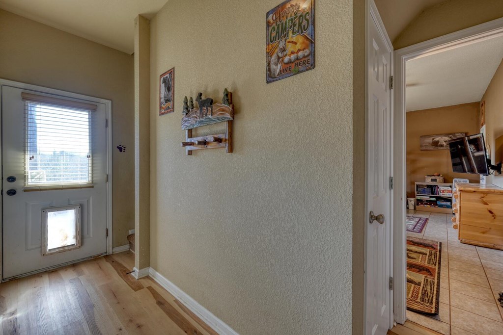 2567 Todd Shook Road Young Harris, GA 30582 - Photo 41 of 62 a view of a hallway with wooden floor and a livingroom