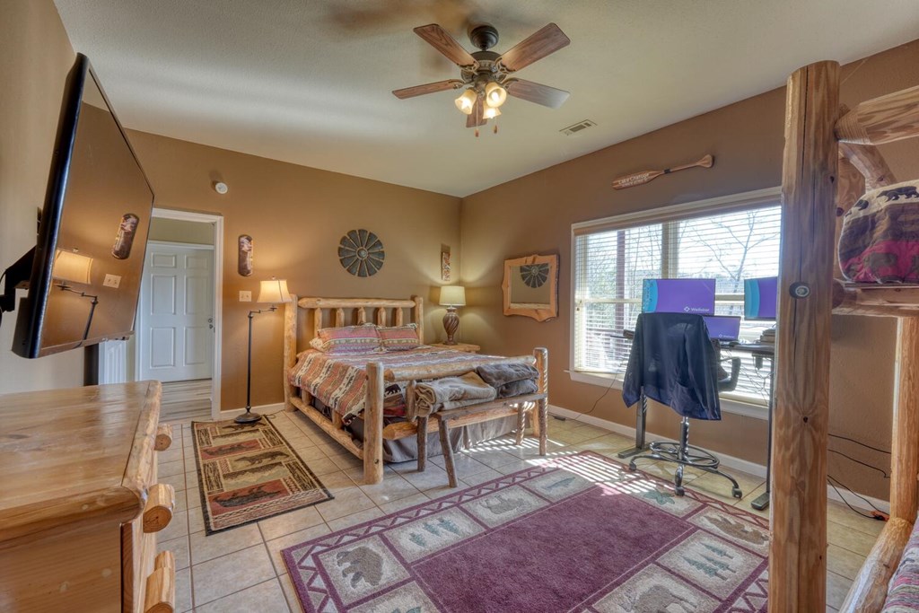 2567 Todd Shook Road Young Harris, GA 30582 - Photo 46 of 62 a spacious bedroom with a bed a dresser and potted plant